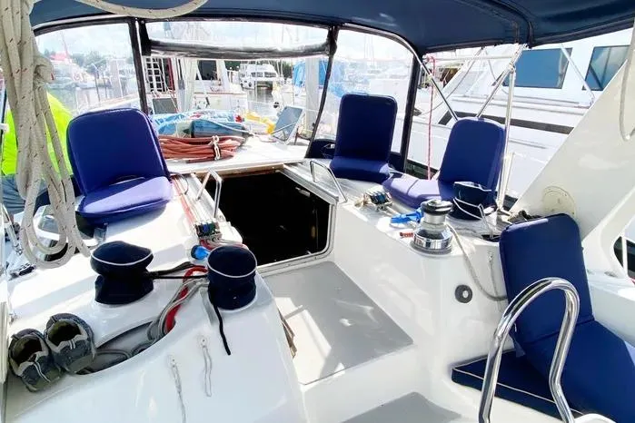 Slide: The Image of Cockpit of a 1997 Hunter 430 sailboat with blue seating and nautical equipment. - 23