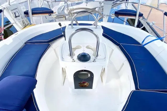 Slide: The Image of Cockpit of 1997 Hunter 430 sailboat with blue cushioned seating and steering wheel. - 24