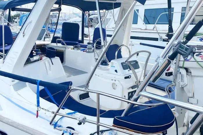 Slide: The Image of Hunter 430 sailboat cockpit, 1997 model, featuring blue seating and navigation equipment. - 27