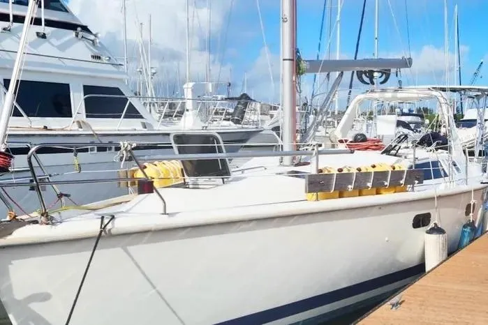 Slide: The Image of 1997 Hunter 430 sailboat docked at marina under clear blue sky. - 4