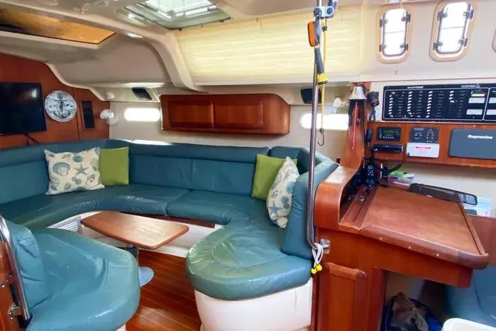 Slide: The Image of Interior of a 1997 Hunter 430 sailboat with cozy seating and navigation area. - 8