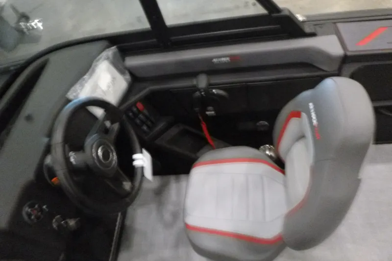 Slide: The Image of 2025 Alumacraft Trophy 185X Sport boat interior with steering wheel and seat. - 10