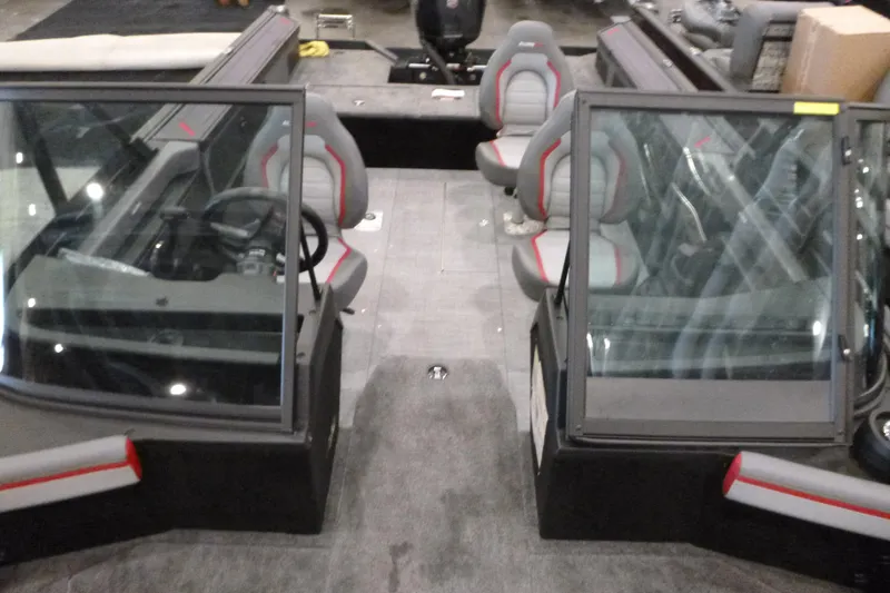 Slide: The Image of 2025 Alumacraft Trophy 185X Sport interior with dual consoles and seating. - 5