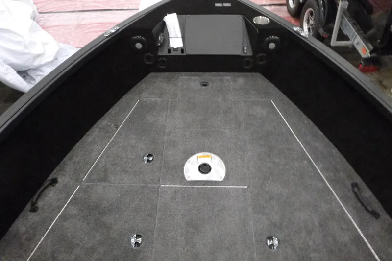 Slide: The Image of 2025 Alumacraft Trophy 185X Sport boat interior with carpeted deck and storage compartments. - 6