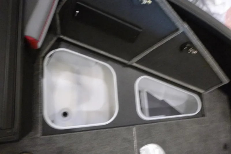 Slide: The Image of 2025 Alumacraft Trophy 185X Sport boat storage compartments, featuring dual bins and secure lids. - 8
