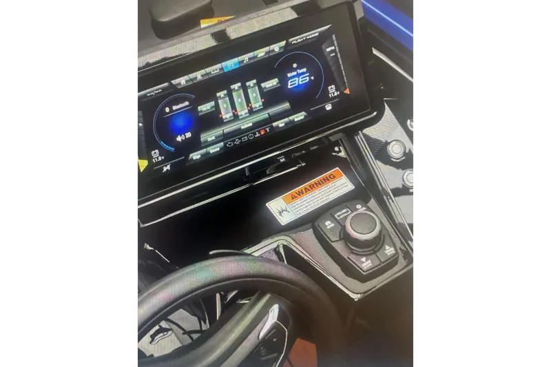 Slide: The Image of Dashboard of 2026 Yamaha Boats 255XD with touchscreen controls and warning label. - 4