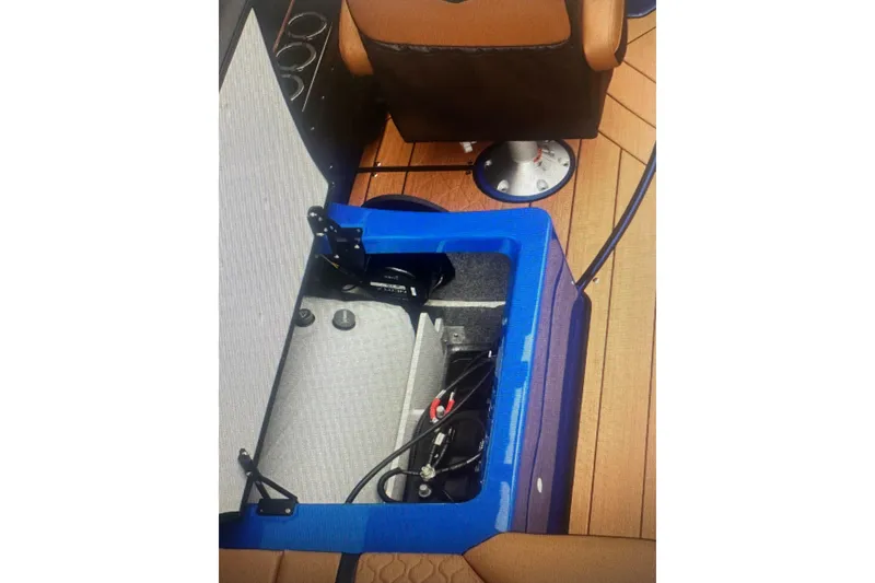 Slide: The Image of 2026 Yamaha Boats 255XD interior storage compartment with visible wiring and seating. - 5