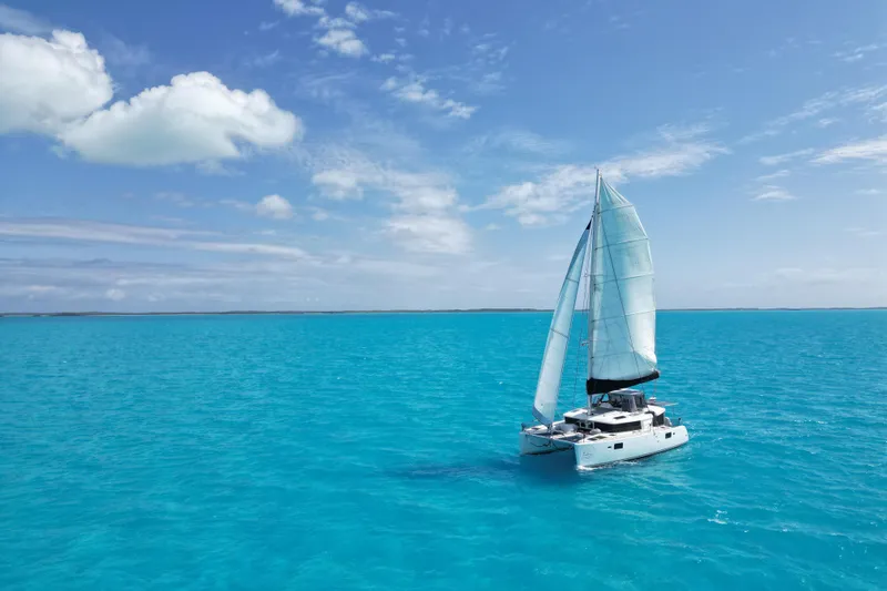 The Image of Sailing Lagoon 450 F catamaran on clear turquoise waters under a bright blue sky. - 0