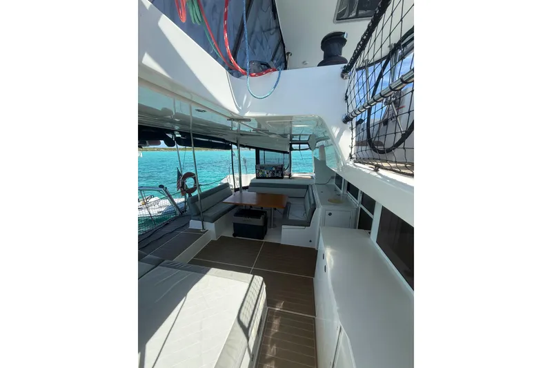 Slide: The Image of 2016 Lagoon 450 F catamaran interior with seating, table, and ocean view. - 11