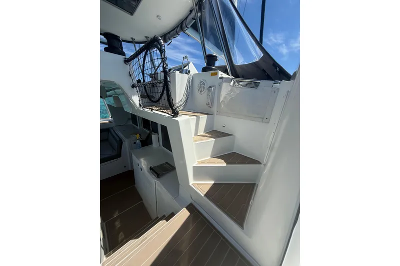 Slide: The Image of Staircase on 2016 Lagoon 450 F yacht, leading to upper deck under clear blue sky. - 12
