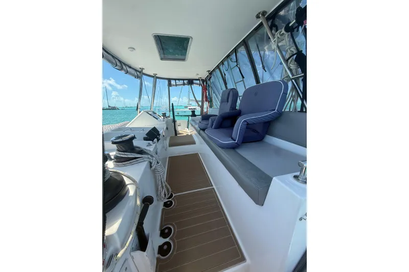 Slide: The Image of Lagoon 450 F 2016 yacht cockpit with seating, ocean view, and clear skies. - 13