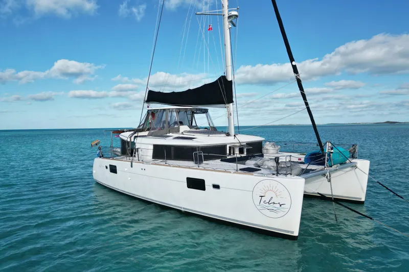 The Image of 2016 Lagoon 450 F catamaran sailing on clear blue waters under a sunny sky. - 2