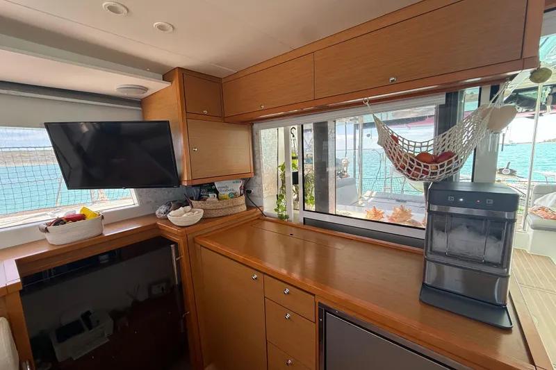 Slide: The Image of Interior of 2016 Lagoon 450 F yacht with kitchen, TV, and ocean view. - 26