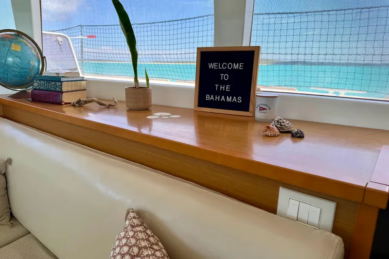 Slide: The Image of Interior of 2016 Lagoon 450 F yacht with "Welcome to the Bahamas" sign and decor. - 28