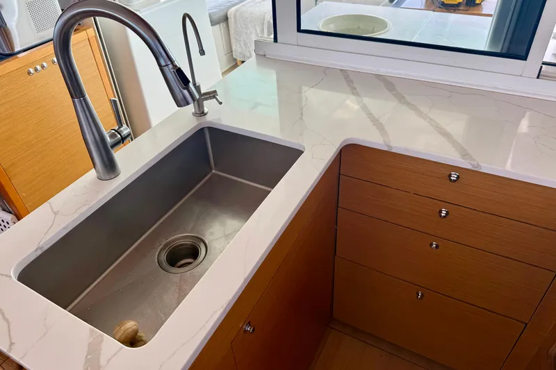 Slide: The Image of Modern kitchen sink with marble countertop on Lagoon 450 F catamaran, 2016 model. - 32