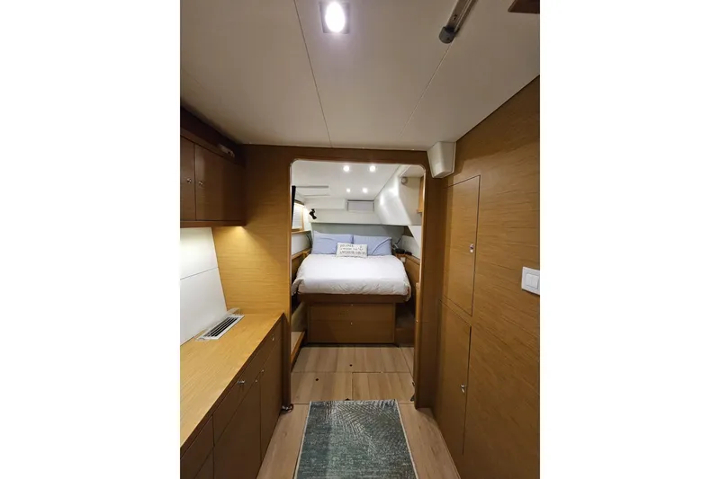 Slide: The Image of Interior of 2016 Lagoon 450 F yacht cabin with cozy bed and wooden furnishings. - 42
