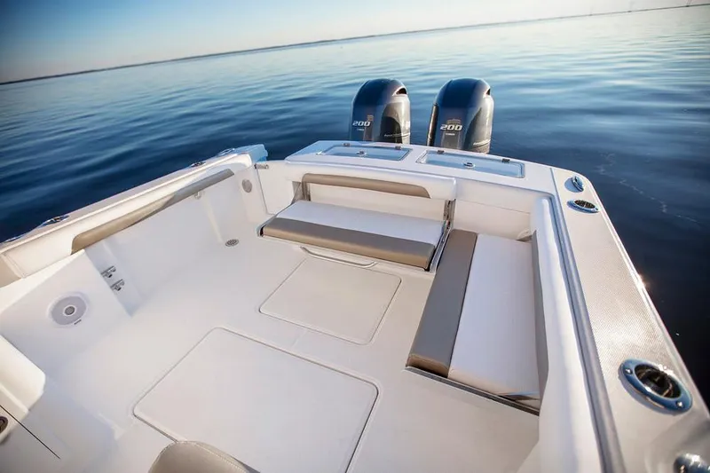 Slide: The Image of 2026 Albemarle 27 Dual Console interior at a boat show, featuring helm and seating area. - 6