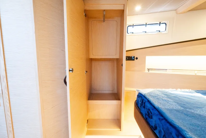 Slide: The Image of Interior of 2023 Solaris Power 44 Open yacht, featuring a wooden wardrobe and cozy cabin. - 103