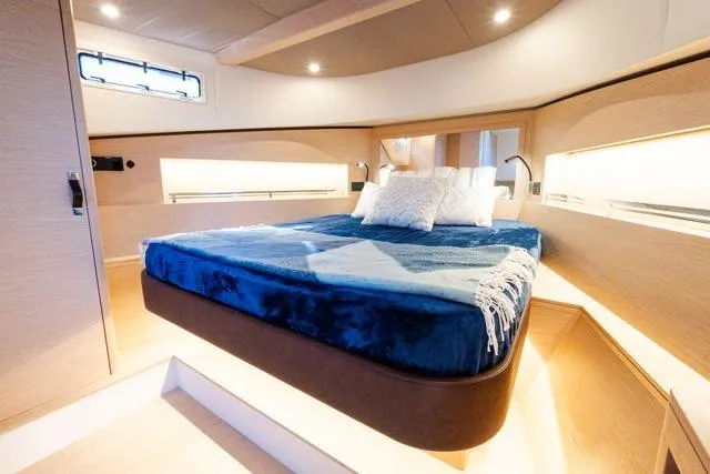 Slide: The Image of Luxurious cabin interior of 2023 Solaris Power 44 Open yacht with cozy bed and modern lighting. - 109