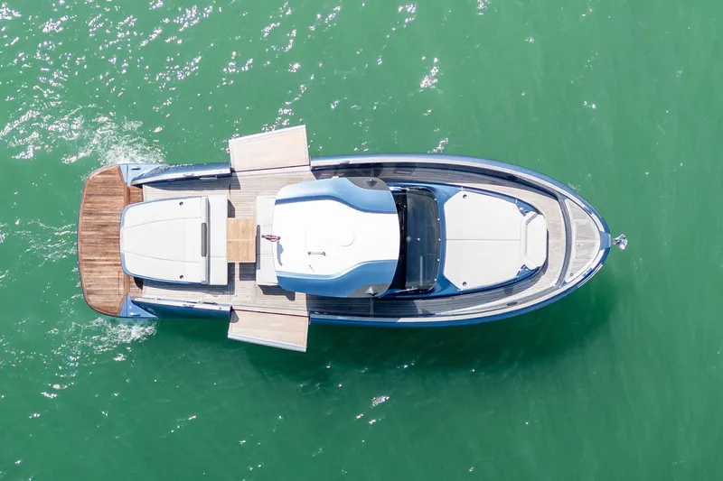 Slide: The Image of Aerial view of 2023 Solaris Power 44 Open yacht on green water. - 12
