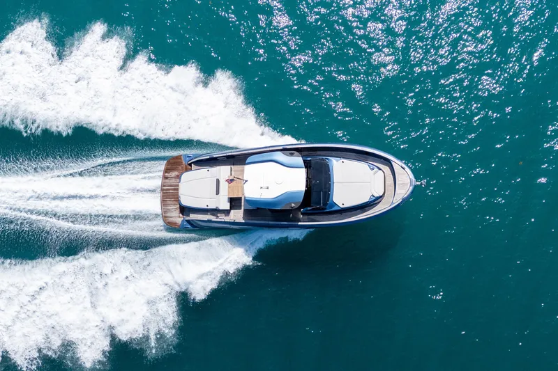 Slide: The Image of Aerial view of 2023 Solaris Power 44 Open yacht cruising on blue ocean waters. - 14