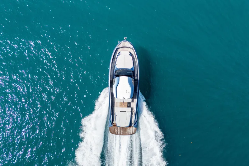 Slide: The Image of Aerial view of 2023 Solaris Power 44 Open yacht cruising on blue water. - 16