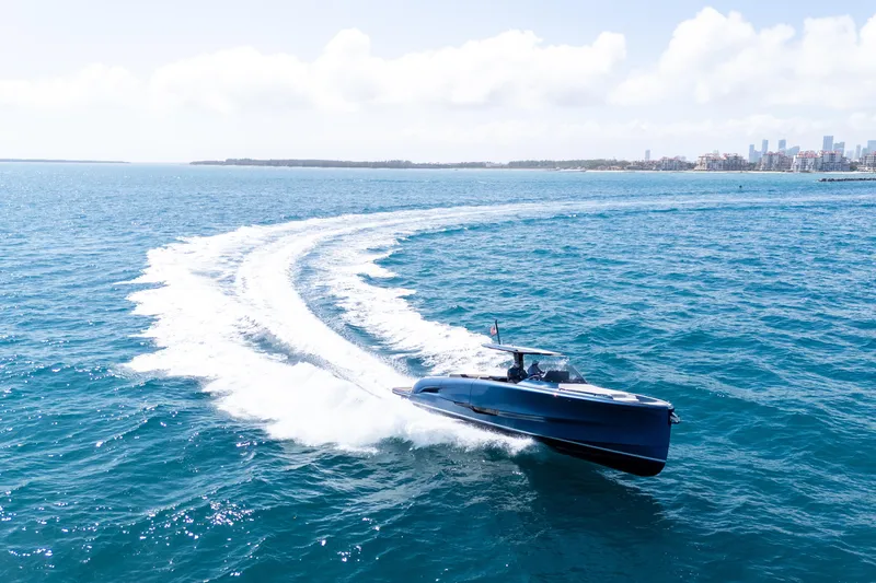 Slide: The Image of 2023 Solaris Power 44 Open yacht cruising on blue ocean near city skyline. - 19