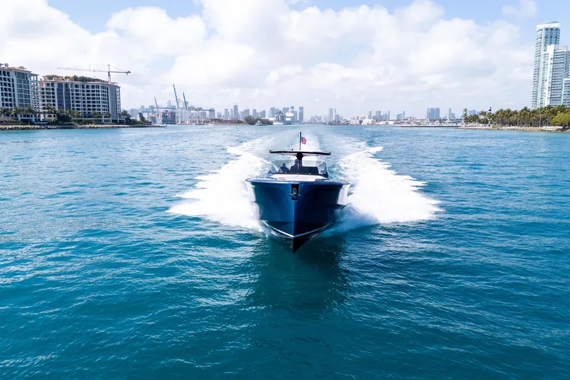 Slide: The Image of 2023 Solaris Power 44 Open yacht cruising in a vibrant coastal cityscape. - 30