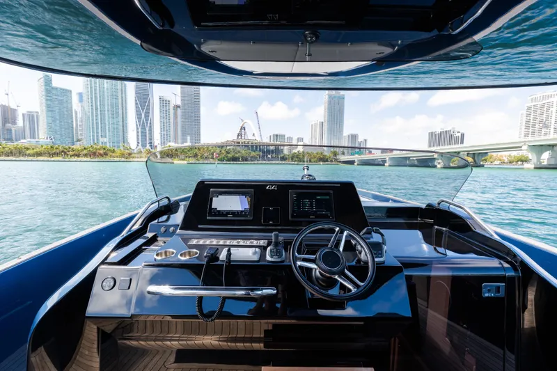 Slide: The Image of 2023 Solaris Power 44 Open yacht helm with city skyline view. - 38