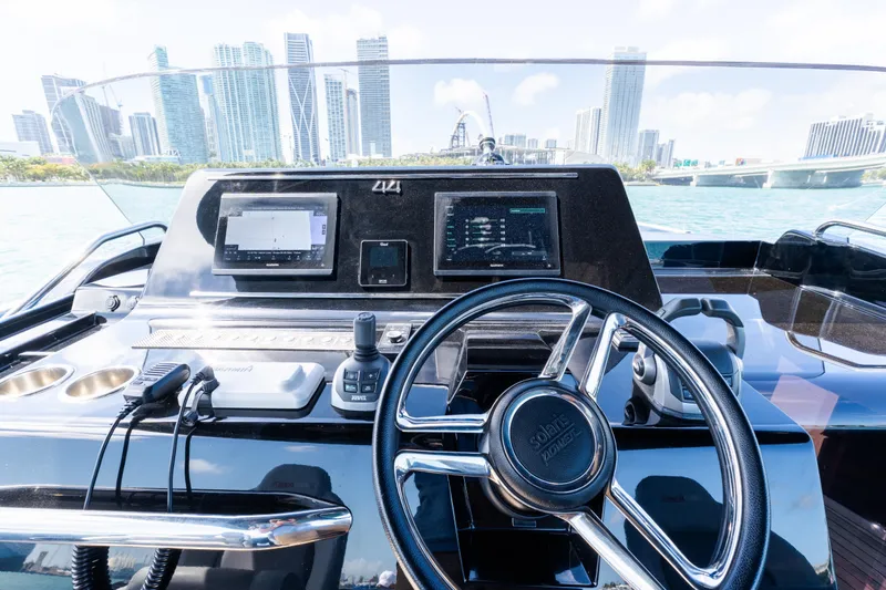 Slide: The Image of 2023 Solaris Power 44 Open yacht dashboard with city skyline in background. - 39