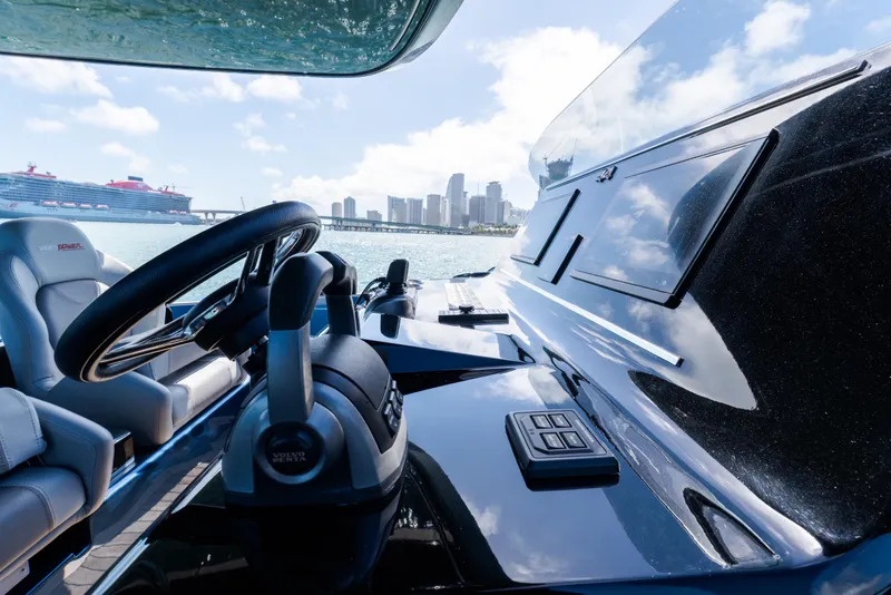 Slide: The Image of 2023 Solaris Power 44 Open yacht helm with city skyline and cruise ship in background. - 41
