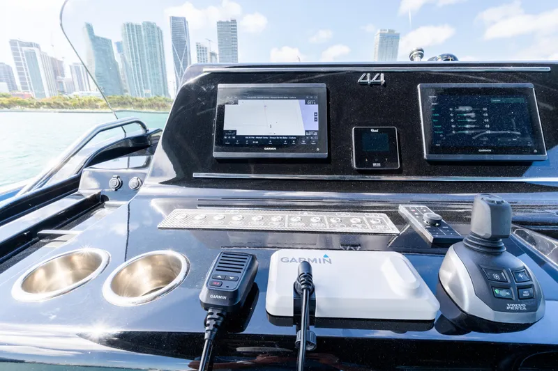 Slide: The Image of Control panel of 2023 Solaris Power 44 Open yacht with city skyline backdrop. - 42
