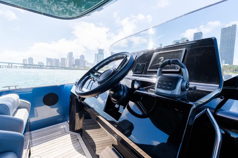 Slide: The Image of Helm of 2023 Solaris Power 44 Open yacht with city skyline view. - 43