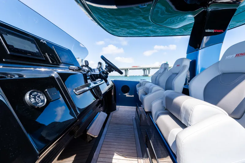 Slide: The Image of 2023 Solaris Power 44 Open yacht interior with sleek dashboard and luxurious seating. - 50