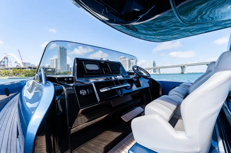 Slide: The Image of 2023 Solaris Power 44 Open yacht cockpit with modern controls, city skyline, and bridge view. - 53