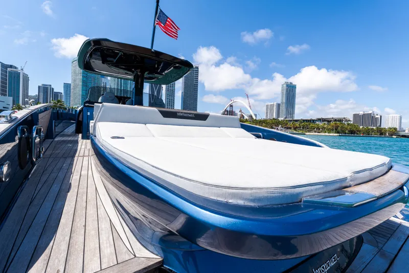 Slide: The Image of 2023 Solaris Power 44 Open yacht with sunbed, city skyline in background. - 65