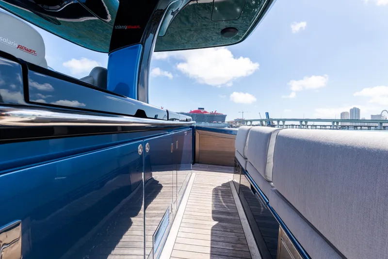 Slide: The Image of 2023 Solaris Power 44 Open yacht, sleek design, docked with cityscape background. - 77