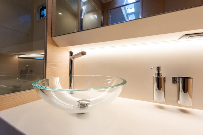 Slide: The Image of Modern bathroom sink with glass basin on 2023 Solaris Power 44 Open yacht. - 91