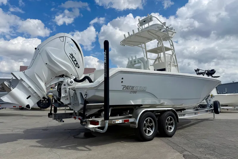 Slide: The Image of 2026 Pathfinder 2700 Open boat on trailer, featuring powerful outboard motor, under a cloudy sky. - 3