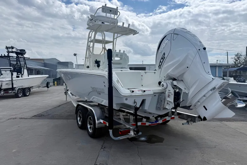 Slide: The Image of 2026 Pathfinder 2700 Open boat on trailer, featuring Yamaha outboard motor, parked outdoors. - 5