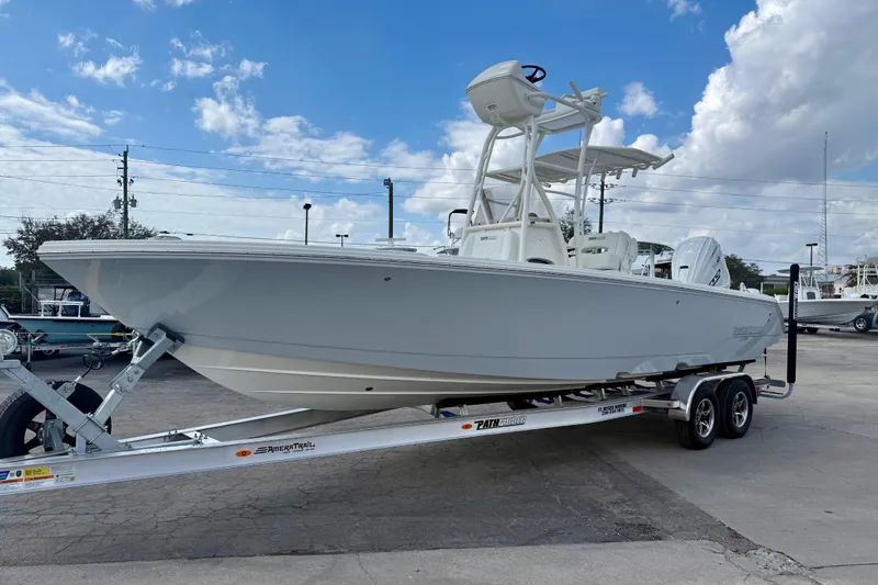 Slide: The Image of 2026 Pathfinder 2700 Open boat on trailer under a partly cloudy sky. - 6