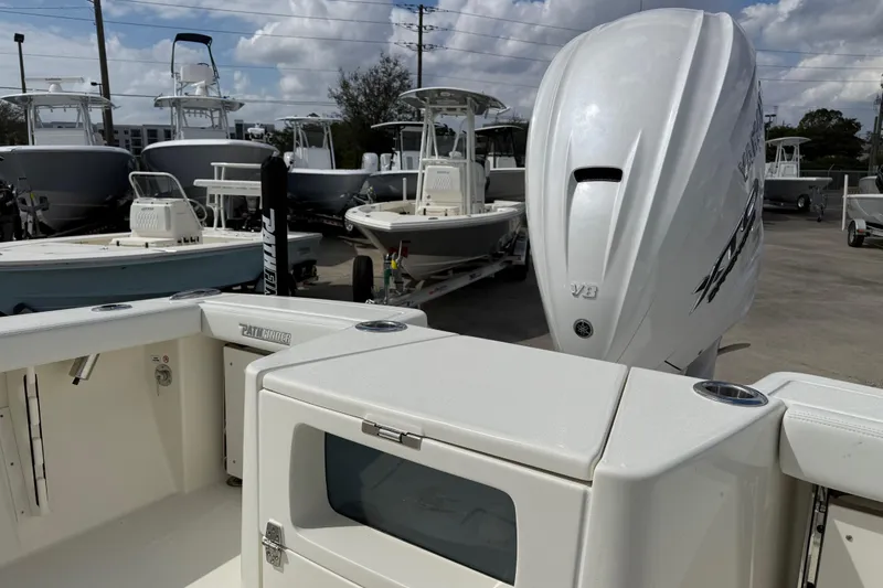 Slide: The Image of 2026 Pathfinder 2700 Open boat with V8 engine, displayed in a marina under cloudy skies. - 7