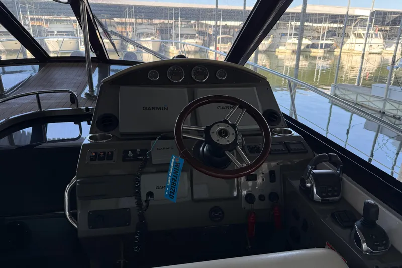 Slide: The Image of Cockpit of 2012 Regal 46 Sport Coupe with Garmin navigation, docked at marina. - 10