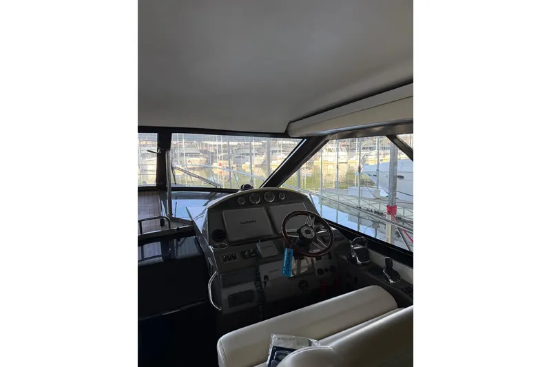 Slide: The Image of Interior view of 2012 Regal 46 Sport Coupe yacht cockpit with steering wheel and controls. - 11