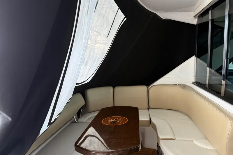 Slide: The Image of Interior of 2012 Regal 46 Sport Coupe with beige seating and wooden table. - 13