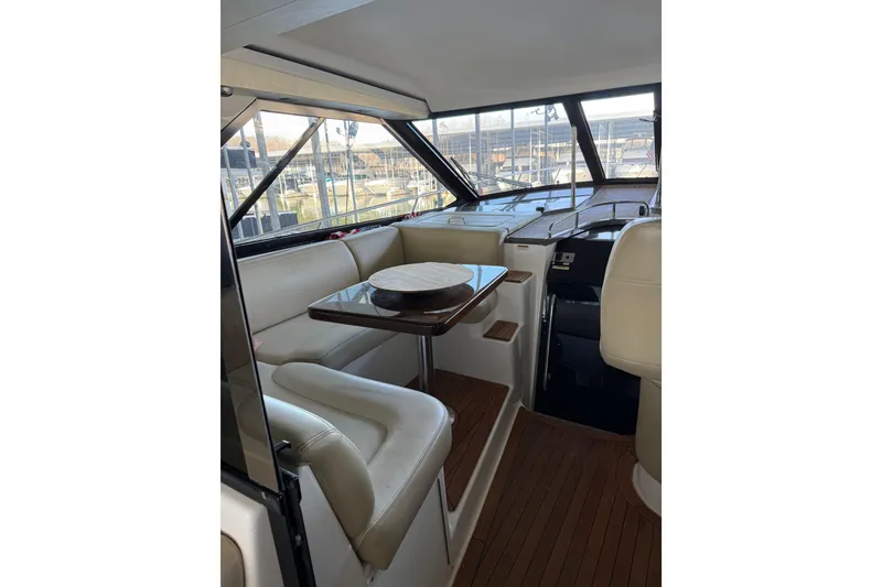 Slide: The Image of Interior of 2012 Regal 46 Sport Coupe with elegant seating and wooden table. - 16