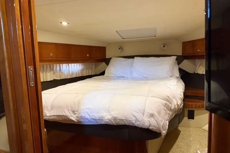 Slide: The Image of Luxurious bedroom interior of 2012 Regal 46 Sport Coupe yacht with cozy bedding. - 23