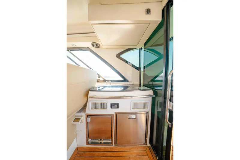 Slide: The Image of 2012 Regal 46 Sport Coupe yacht interior with modern kitchenette and sleek design. - 27