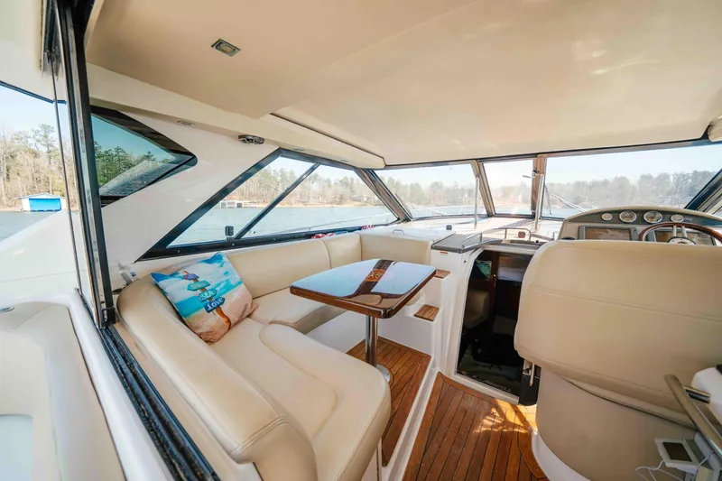 Slide: The Image of Interior of 2012 Regal 46 Sport Coupe yacht with beige seating and wooden accents. - 28