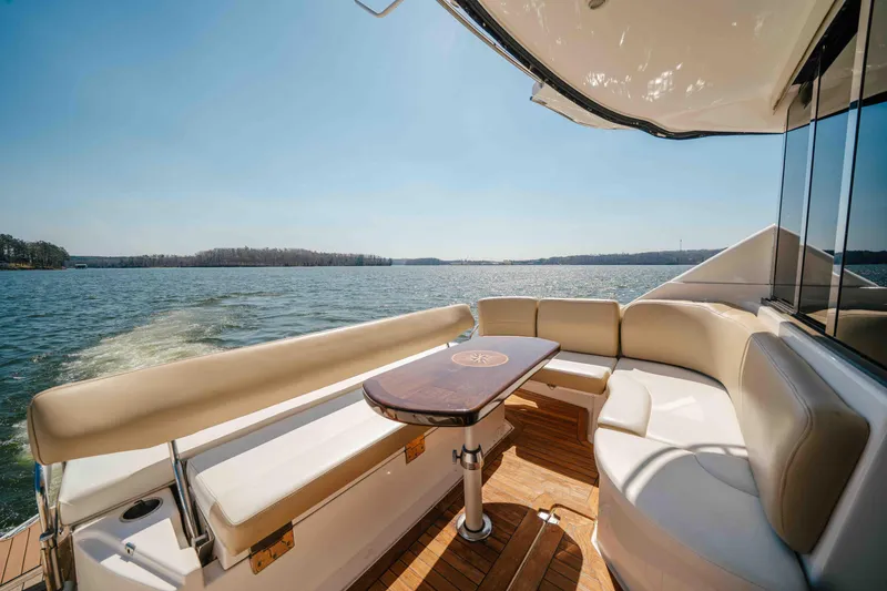 Slide: The Image of Luxurious 2012 Regal 46 Sport Coupe yacht with elegant seating and scenic water view. - 30